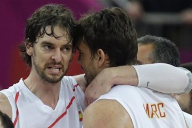 Spain's Pau Gasol, left, embraces his brother Marc after beating Russia during a men's semifinals basketball game at the 2012 Summer Olympics, Friday, Aug. 10, 2012, in London. (AP Photo/Charles Krupa)