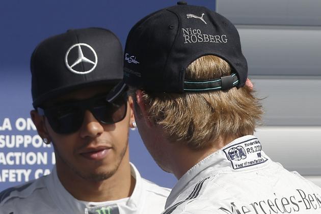 Mercedes driver Nico Rosberg of Germany, right, is congratulated by his teammate after the qualifying session at the Spa-Francorchamps circuit, Belgium, Saturday, Aug. 23, 2014. Nico Rosberg will start the Belgian Grand Prix from pole position after holding off a strong challenge from his Mercedes rival Lewis Hamilton in qualifying on Saturday. Hamilton was ahead of Rosberg on the first two time splits of his final lap but then drifted back, allowing Rosberg to clinch a fourth straight pole and sixth in the past seven races. The German driver leads Hamilton by 11 points in the overall standings. The Belgium Formula One Grand Prix will be held on Sunday. (AP Photo/Luca Bruno)