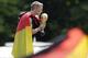 Bastian Schweinsteiger kisses the trophy during a fan party after the arrival of the German national soccer team in Berlin Tuesday, July 15, 2014. Germany beat Argentina 1-0 on Sunday to win its fourth World Cup title. (AP Photo/Petr David Josek)