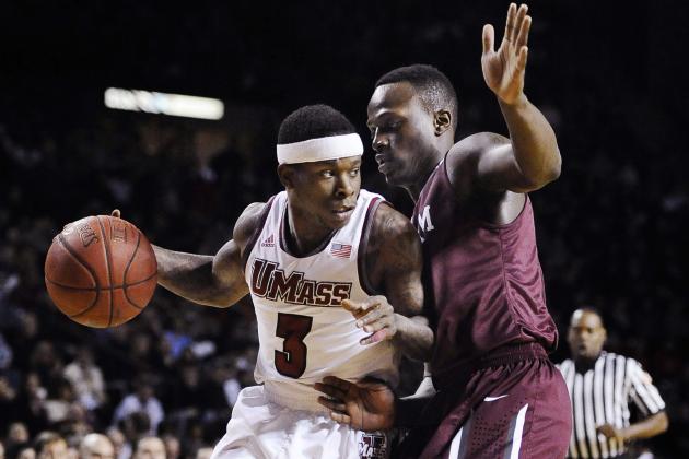 Massachusetts' Chaz Williams, left, drives to the basket as Fordham's Bryan Smith, right, defends during the first half of an NCAA college basketball game, Sunday, Jan. 26, 2014, in Amherst, Mass. (AP Photo/Jessica Hill)