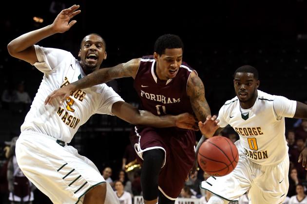 NEW YORK, NY - MARCH 12: Branden Frazier #0 of the Fordham Rams handles the ball against Johnny Williams #2 and Bryon Allen #0 of the George Mason Patriots in the first half during the first round of the Atlantic 10 Men's Basketball Tournament at Barclays Center on March 12, 2014 in the Brooklyn Borough of New York City. (Photo by Mike Lawrie/Getty Images)