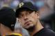 Pittsburgh Pirates starting pitcher Charlie Morton stands in the dugout during the third inning of a baseball game against the San Diego Padres in Pittsburgh Friday, Aug. 8, 2014. (AP Photo/Gene J. Puskar)