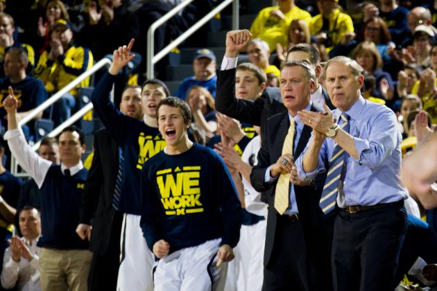 Michigan coach John Beilein, right, and the Michigan bench cheer after a basket during the first half of an NCAA college basketball game against Minnesota at Crisler Center in Ann Arbor, Mich., Saturday, March 1, 2014. Michigan won 66-56. (AP Photo/Tony Ding)