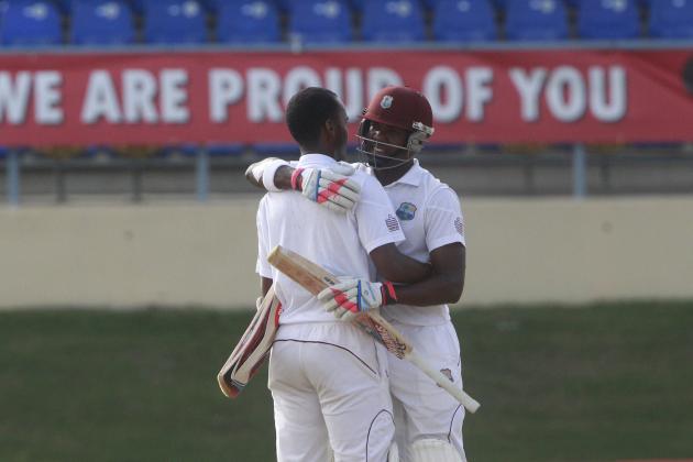 West Indies' batsman Kraigg Brathwaite, left, is hugged by his batting partner Darren Bravo, right, after scoring a half century during the second day of their second cricket Test match against New Zealand in Port of Spain, Trinidad, Tuesday, June 17, 2014. (AP Photo/Arnulfo Franco)