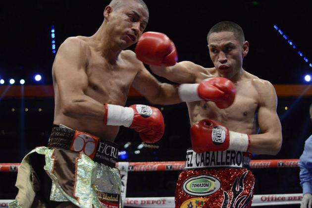 Mexico's Juan Francisco Estrada, right, fights against Milan Melindo of the Philippines during their WBO/WBA Flyweight Title match at the Cotai Arena in Venetian Macao in Macau Saturday July 27, 2013. (AP Photo/Dennis Ho)