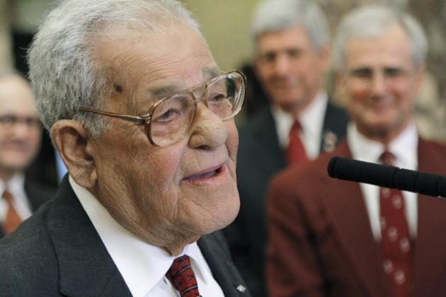 Senators gather around retired Mississippi State radio play-by-play personality Jack Cristil as he finishes his comments before the lawmakers with his trademark signoff,