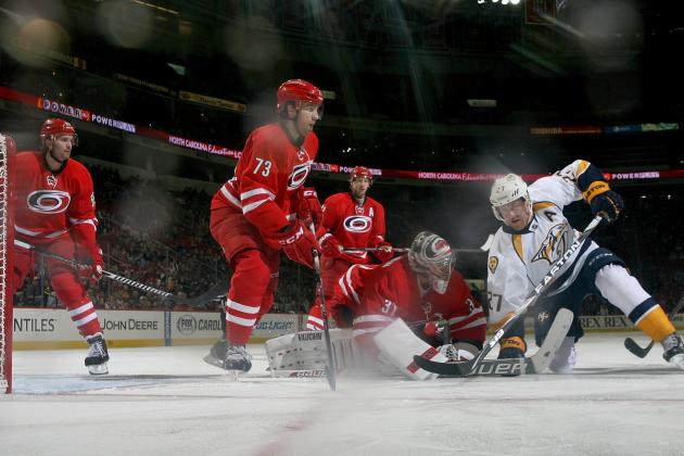 RALEIGH, NC - JANUARY 05: Anton Khudobin #31 of the Carolina Hurricanes comes out of the crease to make a save as Patric Hornqvist #27 of the Nashville Predators attempts to knock the puck loose during their NHL game at PNC Arena on January 5, 2014 in Raleigh, North Carolina.  (Photo by Gregg Forwerck/NHLI via Getty Images)