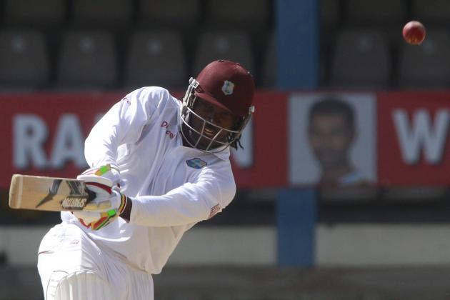 West Indies opening batsman Chris Gayle, left, plays a shot during the second innings on the last day of the second cricket Test match against New Zealand in Port of Spain, Trinidad, Friday, June 20, 2014. West Indies won the second Test match by 10 wickets tying the series 1-1. (AP Photo/Arnulfo Franco)