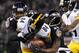 Pittsburgh Steelers wide receiver Antonio Brown (84) is tackled by Baltimore Ravens cornerbacks Corey Graham (24) and Lardarius Webb in the second half of an NFL football game Thursday, Nov. 28, 2013, in Baltimore. (AP Photo/Nick Wass)