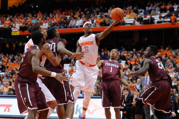 SYRACUSE, NY - NOVEMBER 12: C.J. Fair #5 of the Syracuse Orange lays up a shot in front of Mandell Thomas #1 of the Fordham Rams during the first half at the Carrier Dome on November 12, 2013 in Syracuse, New York. (Photo by Rich Barnes/Getty Images)