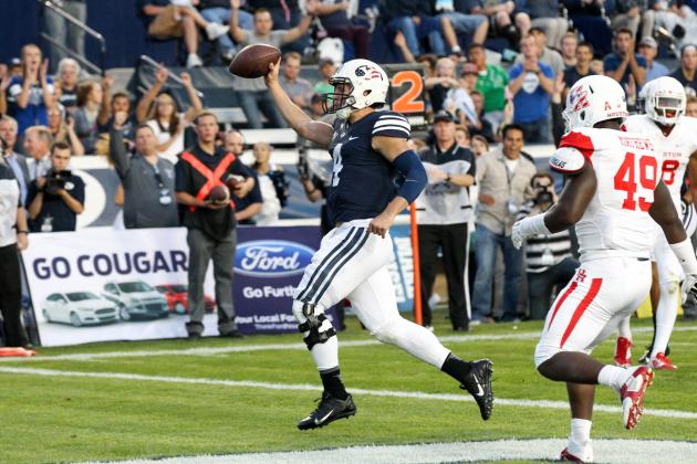 Sep 11, 2014; Provo, UT, USA; Brigham Young Cougars quarterback Taysom Hill (4) scores a touchdown against the Houston Cougars during the first quarter at Lavell Edwards Stadium. Mandatory Credit: Chris Nicoll-USA TODAY Sports