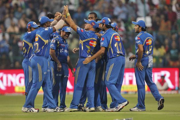 Mumbai Indians' players celebrate the wicket of Royal Challengers Bangalore batsman Virat Kohli, not in the photo, during their Indian Premier League (IPL) match in Bangalore, India, Monday, May 14, 2012. (AP Photo)