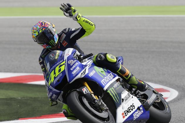 Italy's rider Valentino Rossi waves to his fans after a fourth free practice session for Sunday's San Marino Moto GP grand prix at the Misano circuit, in Misano Adriatico, Italy, Saturday, Sept. 13, 2014. (AP Photo/Antonio Calanni)