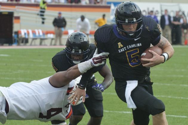 East Carolina quarterback Shane Carden (5) crosses the goal line to score the winning touchdown with seconds to go in the game during an NCAA college football game against Virginia Tech's Ken Ekanem (4)  Saturday, Sept. 13, 2014, at Lane Stadium in Blacksburg, Va. Virginia Tech lost 28-21. (AP Photo/Don Petersen)