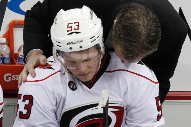 Carolina Hurricanes coach Kirk Muller, top, talks with Jeff Skinner (53) as he sits on the bench after returning to the game following a collision with Pittsburgh Penguins defenseman Brooks Orpik in third period of an NHL hockey game in Pittsburgh Tuesday, Jan. 17, 2012. The Penquins won in a shootout 2-1. (AP Photo/Gene J. Puskar)
