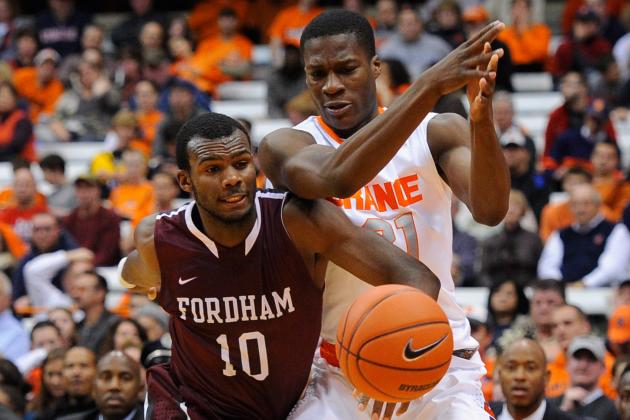 SYRACUSE, NY - NOVEMBER 12: Jon Severe #10 of the Fordham Rams and Tyler Roberson #21 of the Syracuse Orange battle for a loose ball during the second half at the Carrier Dome on November 12, 2013 in Syracuse, New York. Syracuse defeated Fordham 89-74. (Photo by Rich Barnes/Getty Images)