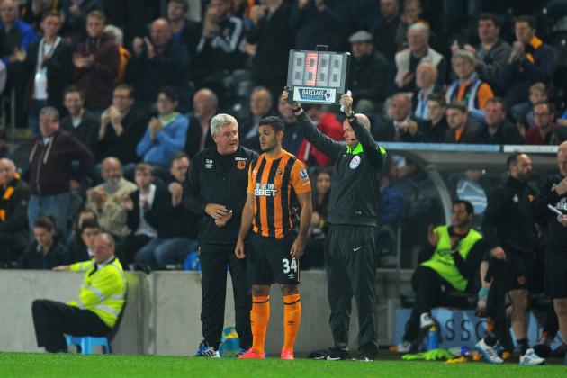 HULL, ENGLAND - SEPTEMBER 15:  New Hull City signing Hatem Ben Arfa gets some advice from manager Steve Bruce before coming on for his debut during the Barclays Premier League match between Hull City and West Ham United at KC Stadium on September 15, 2014 in Hull, England.  (Photo by Stu Forster/Getty Images)