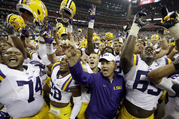 LSU coach Les Miles, center, is surrounded by his team as they celebrate beating Wisconsin in an NCAA college football game Saturday, Aug. 30, 2014, in Houston. LSU won 28-24. (AP Photo/David J. Phillip)