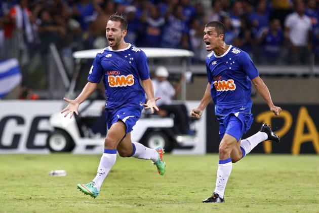 FILE - In this March 20, 2014 file photo, Everton Ribeiro of Brazil's Cruzeiro, left, celebrates his goal with teammate Egidio, against Uruguay’s Defensor during a Copa Libertadores soccer game in Belo Horizonte, Brazil. The Brazilian league starts this weekend with Cruzeiro trying to defend its title in a championship already marked by court disputes prompted by a controversial finish last year. A day before kickoff, there are ongoing lawsuits by two clubs claiming they also deserve to play in the first division this year. (AP Photo/Bruno Magalhaes, File)