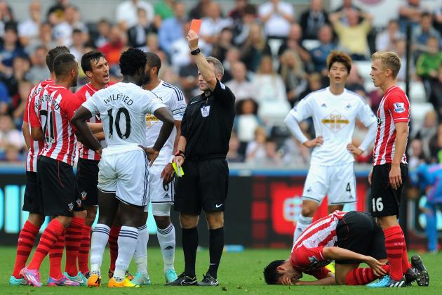 SWANSEA, WALES - SEPTEMBER 20:  Wilfried Bony of Swansea (10) receives a red card for a second bookable offence from referee Jonathan Moss for a foul on Maya Yoshida of Southampton during the Barclays Premier League match between Swansea City and Southampton at Liberty Stadium on September 20, 2014 in Swansea, Wales.  (Photo by Stu Forster/Getty Images)