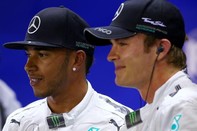 SINGAPORE - SEPTEMBER 20:  Lewis Hamilton of Great Britain and Mercedes GP poses next to Nico Rosberg of Germany and Mercedes GP after claiming pole position during qualifying ahead of the Singapore Formula One Grand Prix at Marina Bay Street on September 20, 2014 in Singapore, Singapore.  (Photo by Mark Thompson/Getty Images)