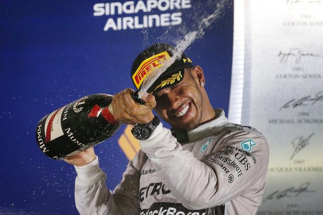 Mercedes driver Lewis Hamilton of Britain celebrates after winning the Singapore Formula One Grand Prix on the Marina Bay City Circuit in Singapore, Sunday, Sept. 21, 2014. (AP Photo/Wong Maye-E)