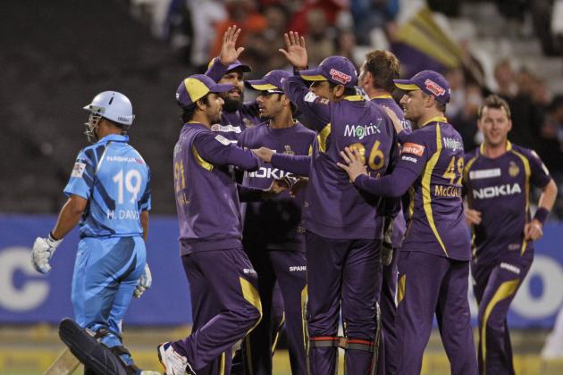 Titans Henry Davids, left, walks of the field as Kolkata Knight Riders celebrate taking his wicket during a Champions League Twenty20 cricket game in Cape Town, South Africa, Sunday, Oct. 21, 2012. (AP Photo/Schalk van Zuydam)