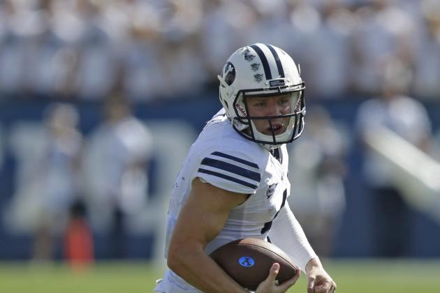 Brigham Young quarterback Taysom Hill (4) carries the ball in the second quarter during an NCAA college football game against Virginia Saturday, Sept. 20, 2014, in Provo, Utah. (AP Photo/Rick Bowmer)