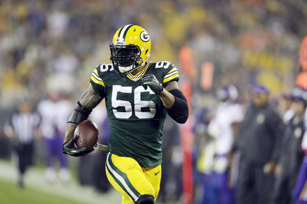 Green Bay Packers' Julius Peppers runs back an interception 49-yards for a touchdown during the first half of an NFL football game against the Minnesota Vikings Thursday, Oct. 2, 2014, in Green Bay, Wis. (AP Photo/Tom Lynn)