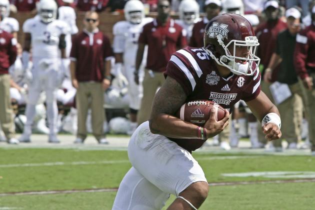 Mississippi State quarterback Dak Prescott (15) gains additional yardage after receiving a pass during the first half of an NCAA college football game against Texas A&M in Starkville, Miss., Saturday, Oct. 4, 2014. (AP Photo/Jim Lytle)
