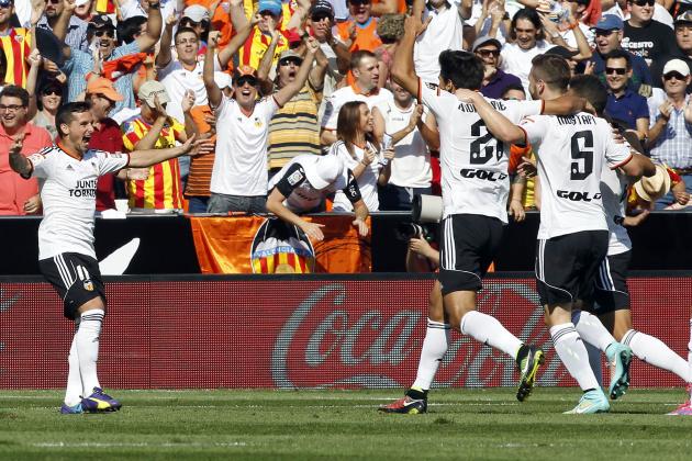 Valencia's Piatti, left, celebrates after scoring against Atletico Madrid, during a Spanish La Liga soccer match at the Mestalla stadium in Valencia, Spain, Saturday, Oct. 4, 2014.(AP Photo/Alberto Saiz)