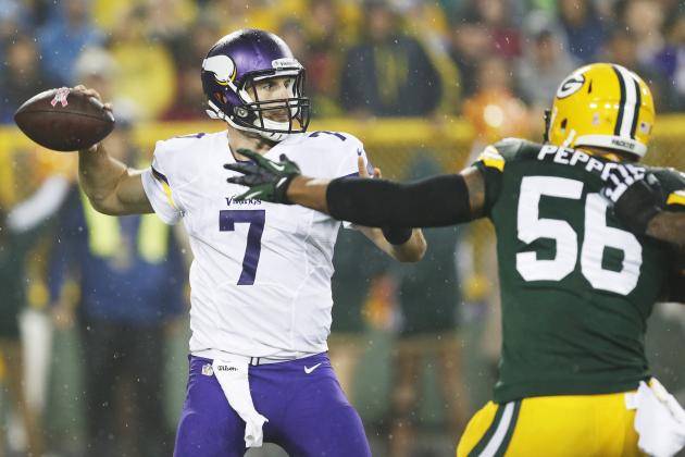Minnesota Vikings' Christian Ponder is pressured by Green Bay Packers' Julius Peppers (56) during the first half of an NFL football game Thursday, Oct. 2, 2014, in Green Bay, Wis. (AP Photo/Mike Roemer)
