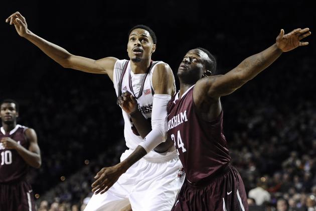 Massachusetts' Raphiael Putney, left, and Fordham's Bryan Smith, right, look for a rebound during the first half of an NCAA college basketball game, Sunday, Jan. 26, 2014, in Amherst, Mass. (AP Photo/Jessica Hill)