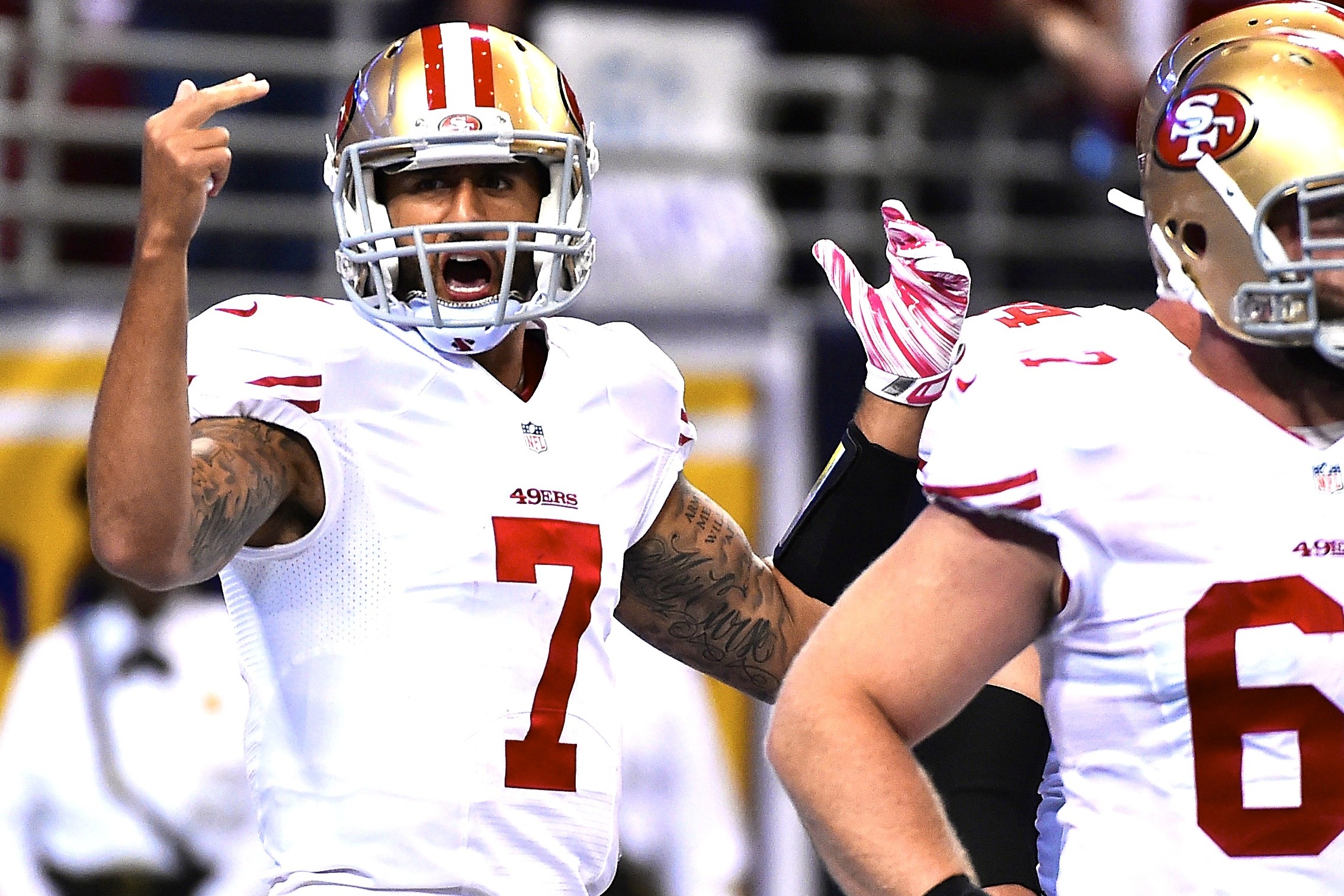 FILE - At left, in a Dec. 24, 2016, file photo, San Francisco 49ers  quarterback Colin Kaepernick talks during a news conference after an NFL  football game against the Los Angeles Rams