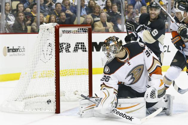 Anaheim Ducks goalie John Gibson (36) looks back at the puck as Pittsburgh Penguins' Pascal Dupuis (9) smiles on the goal by Sidney Crosby in the second period of an NHL hockey game on Thursday, Oct. 9, 2014 in Pittsburgh. (AP Photo/Keith Srakocic)