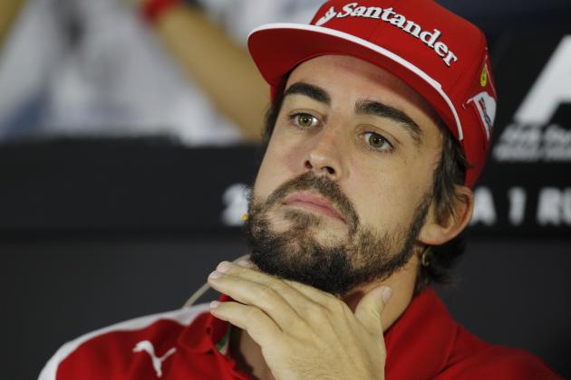 Ferrari driver Fernando Alonso of Spain gestures as he speaks with reporters at the Sochi Autodrom Formula One circuit, in Sochi, Russia, Thursday, Oct. 9, 2014. Formula One drivers say they will race this weekend's Russia Grand Prix for Jules Bianchi, who was seriously injured in an accident last week in Japan. Alonso says the race in Sochi will be