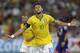 Brazil's Neymar celebrates after scoring his fourth goal against Japan during an international friendly soccer match in Singapore, Tuesday, Oct. 14, 2014. (AP Photo/Wong Maye-E)