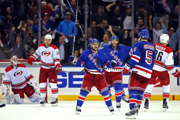 Oct 16, 2014; New York, NY, USA; New York Rangers center Derick Brassard (16) celebrates scoring a goal on Carolina Hurricanes goalie Anton Khudobin (31) with defenseman Dan Girardi (5) and right wing Mats Zuccarello (36) during the third period at Madison Square Garden. The Rangers defeated the Hurricanes 2-1. Mandatory Credit: Adam Hunger-USA TODAY Sports