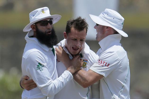 South African test cricket captain Hashim Amla, left, and AB de Villiers, right, congratulate bowler Dale Steyn for the dismissal of Sri Lankan batsman Dilruwan Perera during the fifth day of the first test cricket match in Galle, Sri Lanka, Sunday, July 20, 2014. (AP Photo/Eranga Jayawardena)