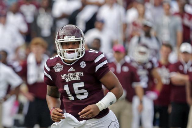 Mississippi State quarterback Dak Prescott (15) runs across the field in the first half of their NCAA college football game against Auburn in Starkville, Miss., Saturday, Oct 11, 2014. No. 3 Mississippi State beat No. 2 Auburn 38-23. (AP Photo/Rogelio V. Solis)