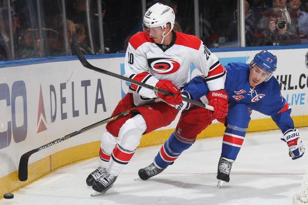 NEW YORK, NY - OCTOBER 16:  Ryan McDonagh #27 of the New York Rangers battles for the puck against Riley Nash #20 of the Carolina Hurricanes at Madison Square Garden on October 16, 2014 in New York City. (Photo by Jared Silber/NHLI via Getty Images)