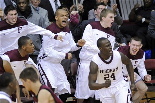 Fordham players celebrate after Bryan Smith (24) hit a 3-point shot during the second half of an NCAA college basketball game against Harvard on Tuesday, Jan. 3, 2012, in New York. Fordham defeated Harvard 60-54. (AP Photo/Bill Kostroun)
