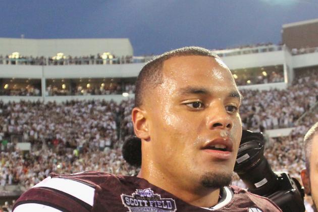 Mississippi State quarterback Dak Prescott (15) walks through off the field following their 38-23 win over No. 2 Auburn in an NCAA college football game in Starkville, Miss., Saturday, Oct. 11, 2014. (AP Photo/Jim Lytle)