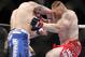 Shane Carwin, left, trades punches with Brock Lesnar during their UFC heavyweight mixed martial arts title match Saturday, July 3, 2010, at The MGM Grand Garden Arena in Las Vegas. (AP Photo/Eric Jamison)