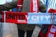 MANCHESTER, ENGLAND - MARCH 25: A vendor sells match scarves prior to the Barclays Premier League match between Manchester United and Manchester City at Old Trafford on March 25, 2014 in Manchester, England. (Photo by Alex Livesey/Getty Images)