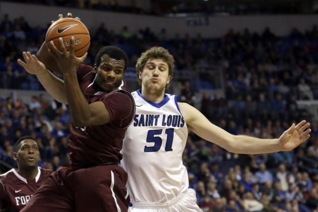 Fordham's Jon Severe, left, grabs a rebound along side Saint Louis' Rob Loe during the second half of an NCAA college basketball game Saturday, Jan. 18, 2014, in St. Louis. Saint Louis won 70-48. (AP Photo/Jeff Roberson)
