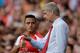 Arsenal's French manager Arsene Wenger, right, gives instructions to his new signing Alexis Sanchez as he substituted on to make his debut, during the Emirates Cup soccer match between between Arsenal and Benfica at Arsenal's Emirates Stadium in London, Saturday, Aug. 2, 2014. (AP Photo/Matt Dunham)