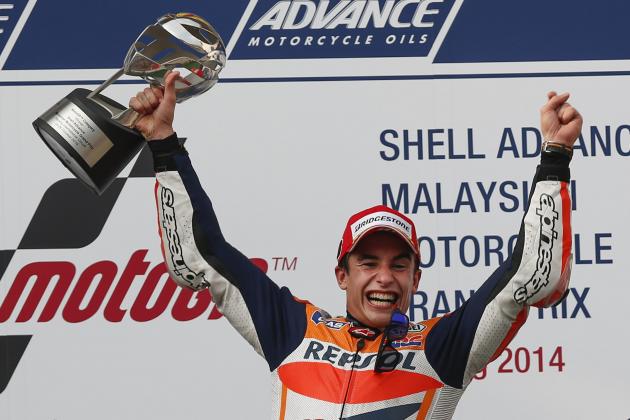 MotoGP rider Marc Marquez of Spain celebrates after winning the Malaysian Motorcycle Grand Prix in Sepang, Malaysia, Sunday, Oct. 26, 2014. (AP Photo/Vincent Thian)