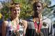 First place female finisher Meghan Curran, left, from Moorestown, N.J., and first place male finisher Samuel Kosgei, from Junction City, Kan., wearing their laurel wreaths and holding their trophies, which depict the Iwo Jima Memorial, pose for photo after the running of the 39th Marine Corps Marathon, Sunday, Oct. 26, 2014 in Arlington, Va. The race includes runners from 59 nations and each branch of the U.S. armed forces. (AP Photo/Alex Brandon)