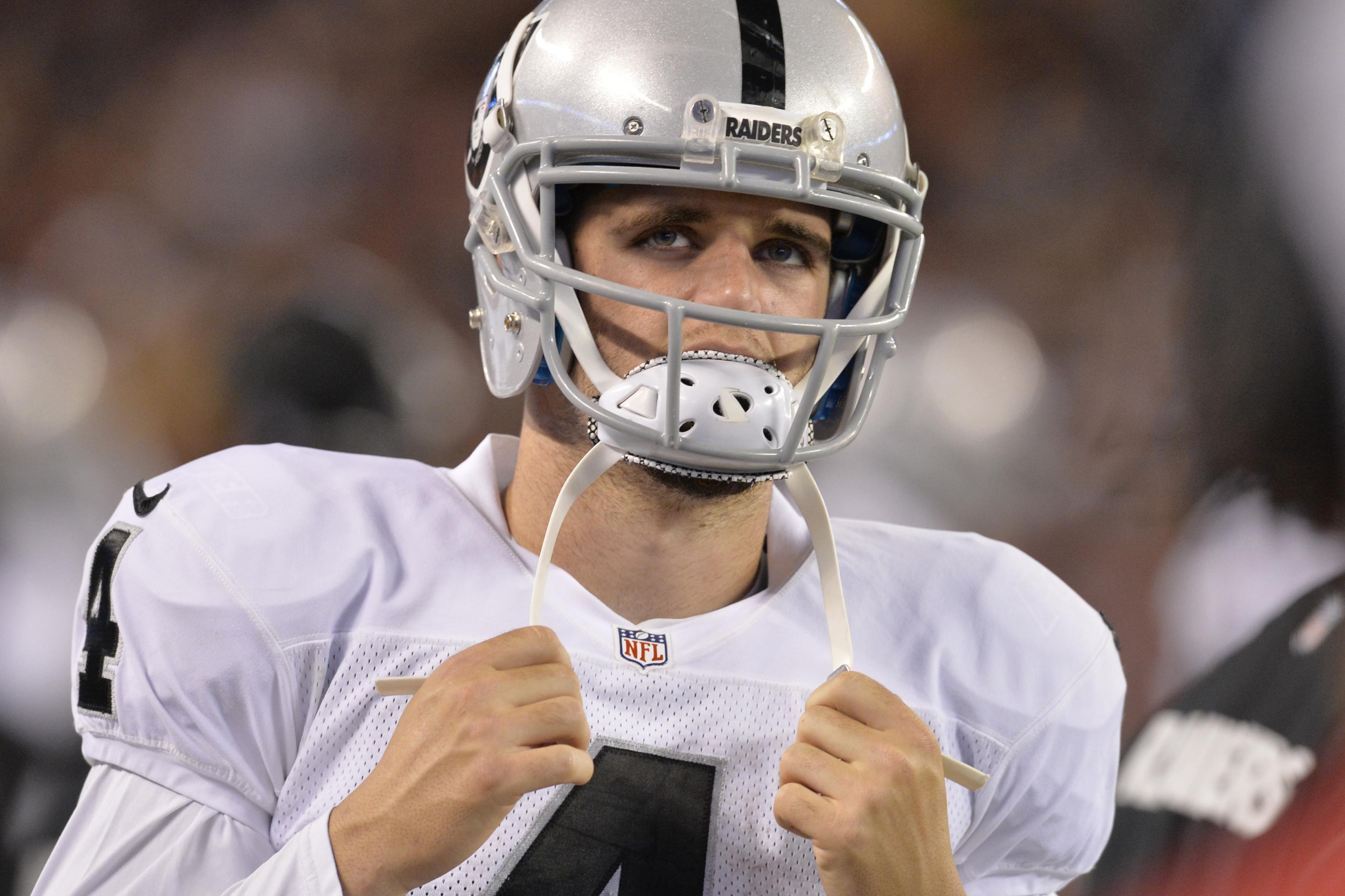 Oakland Raiders' Derek Carr tosses a few passes, still little